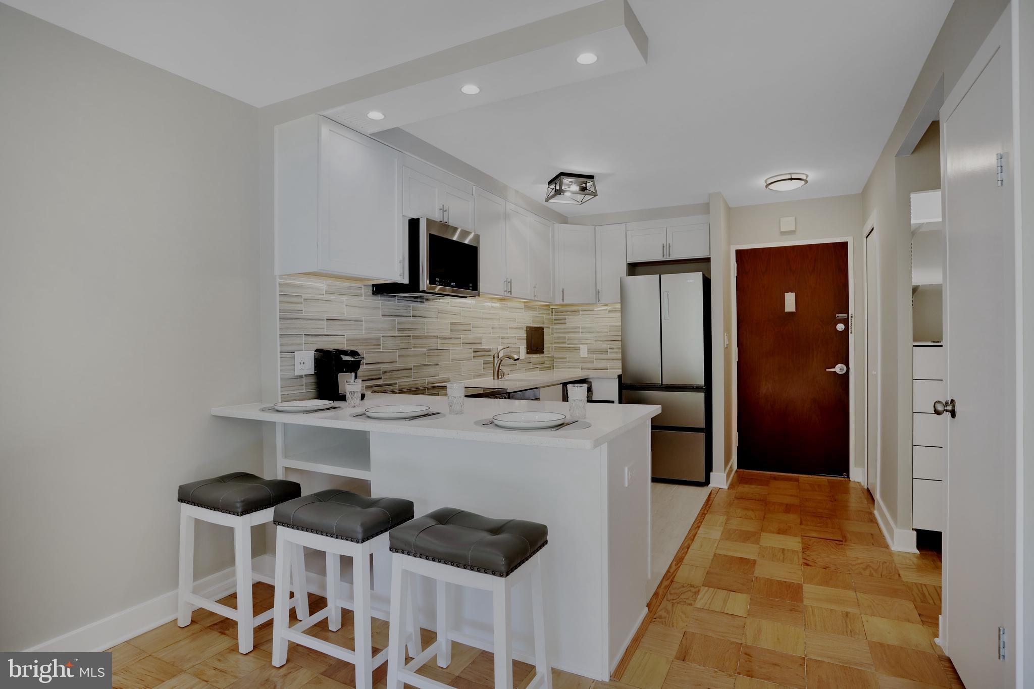 a kitchen with stainless steel appliances a refrigerator and a stove top oven