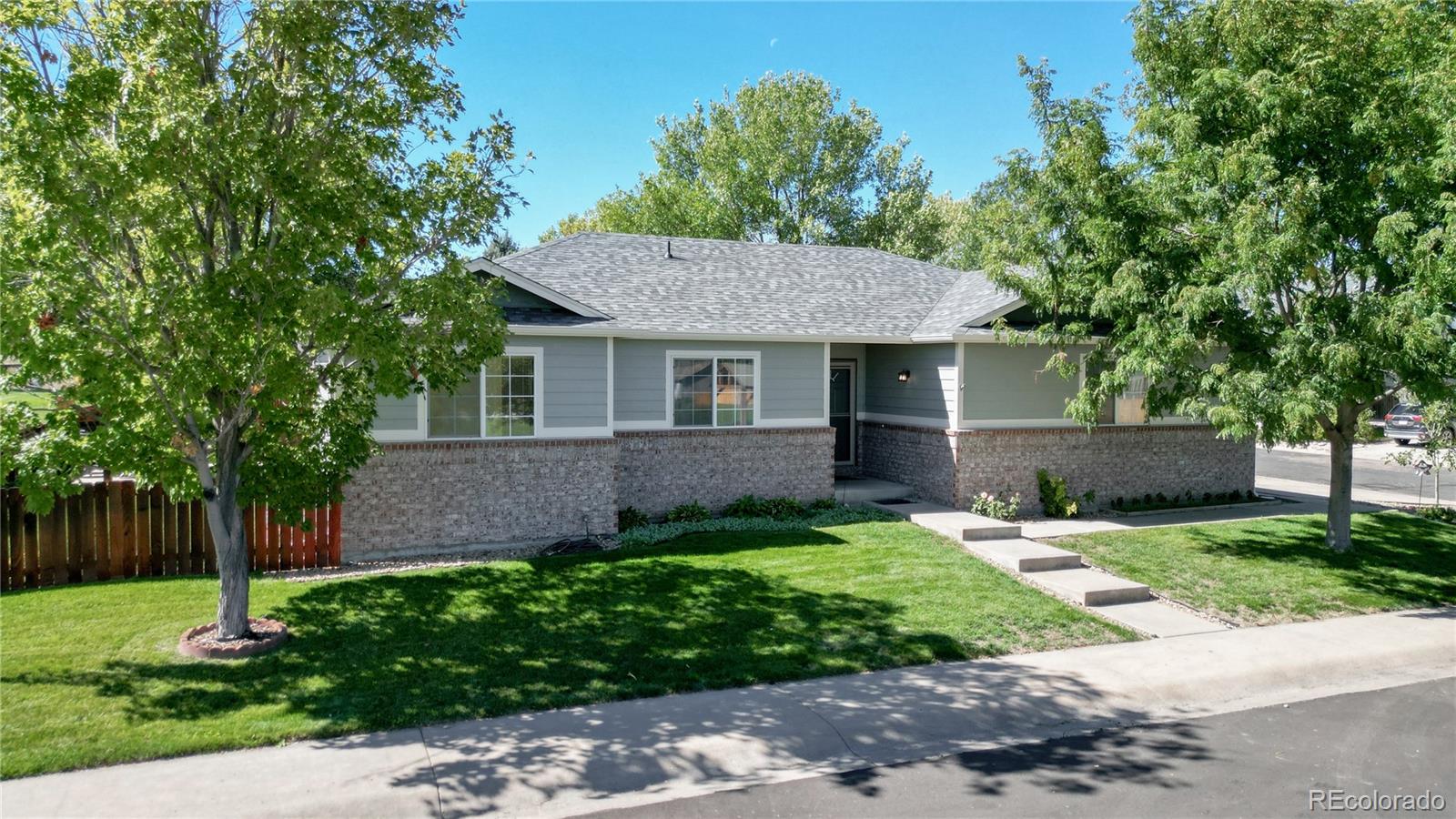 a front view of a house with a garden and yard