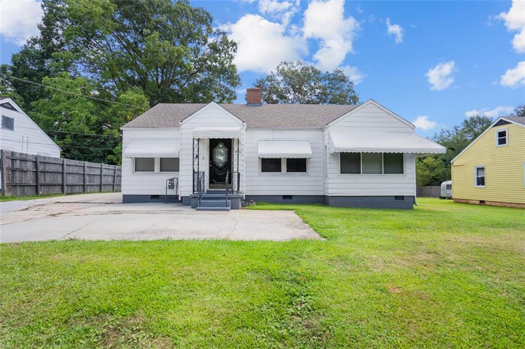 a view of a house with a backyard and a tree