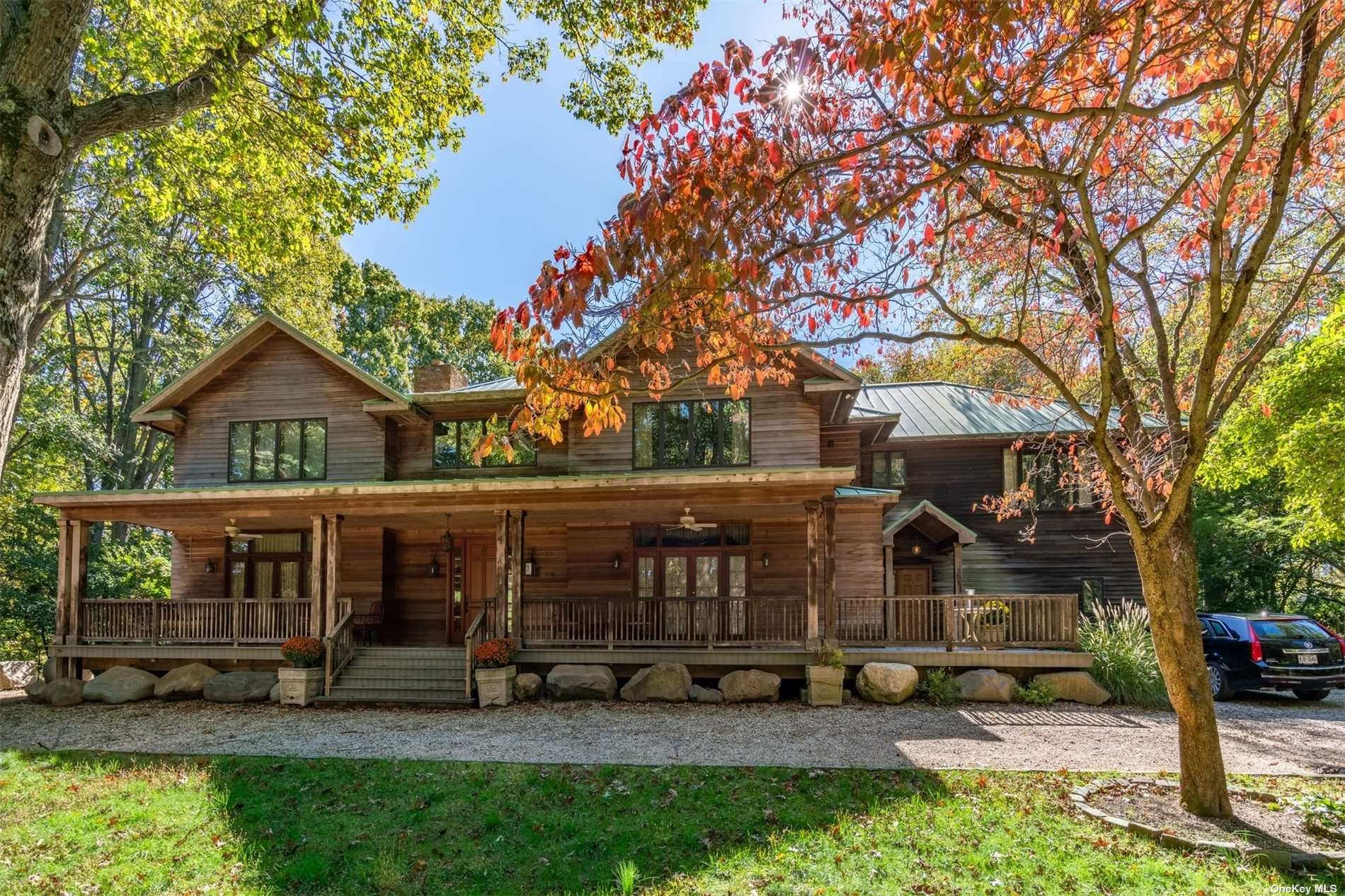 a front view of house with yard and trees around