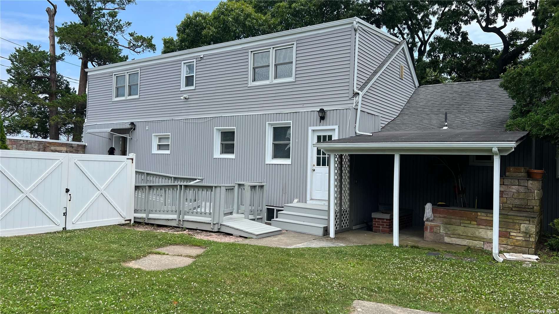 a view of a house with a yard and sitting area