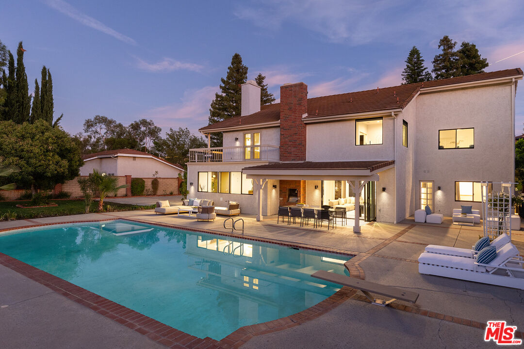 a swimming pool view with a outdoor seating