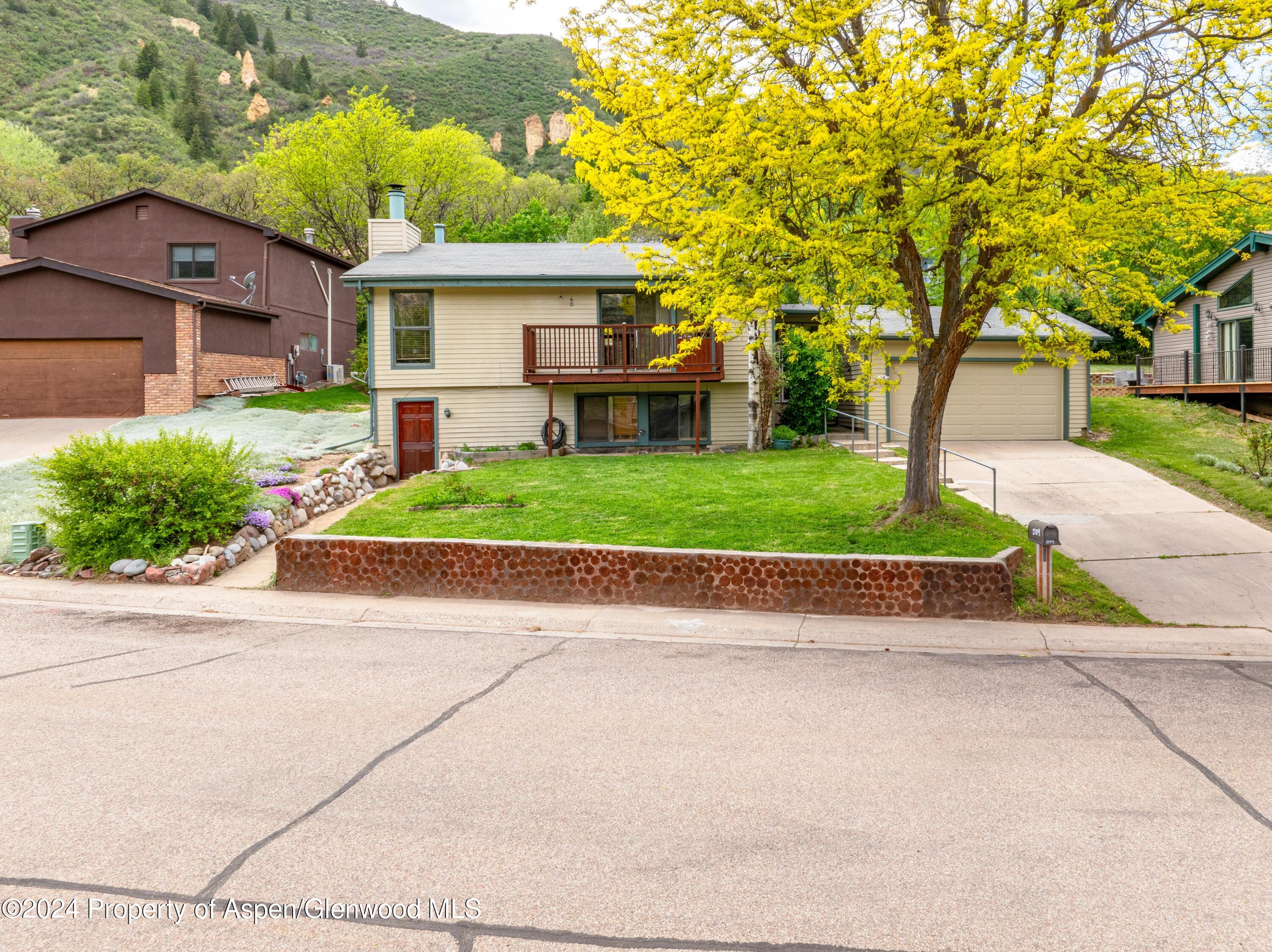 a front view of a house with a yard and a garage