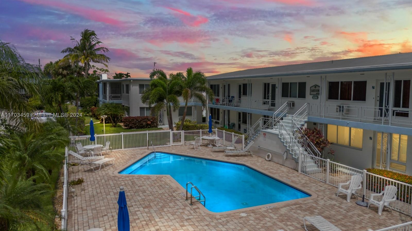 a view of a house with swimming pool and sitting area