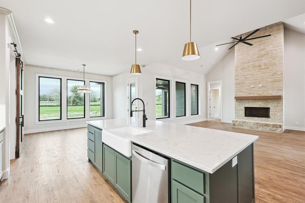 a kitchen with a sink a counter top space and a wooden floor