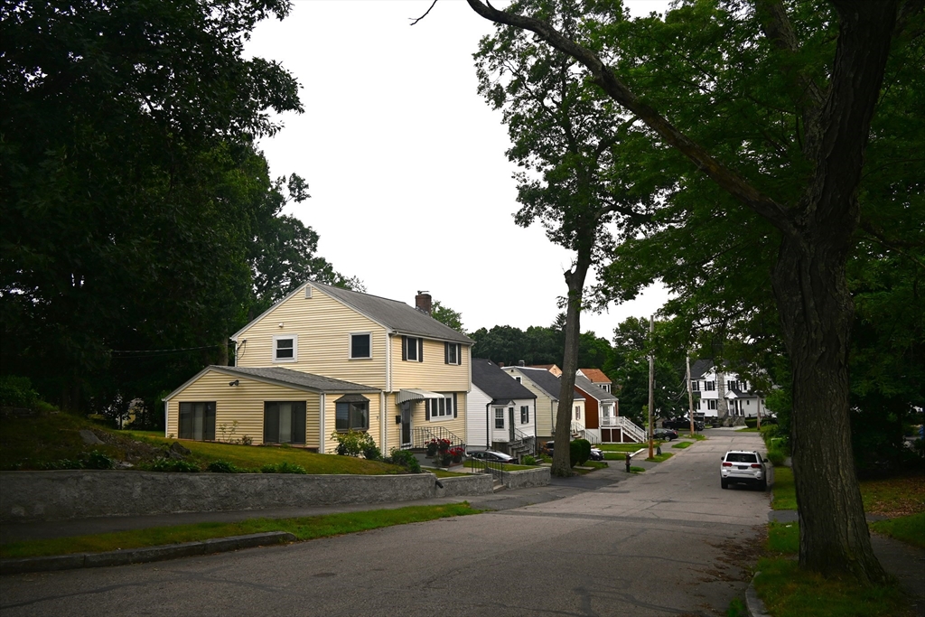 a front view of a house with a garden