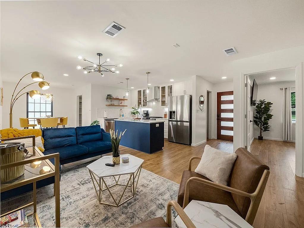 a living room with furniture and wooden floor