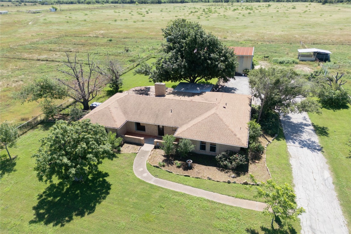 an aerial view of a house with a yard