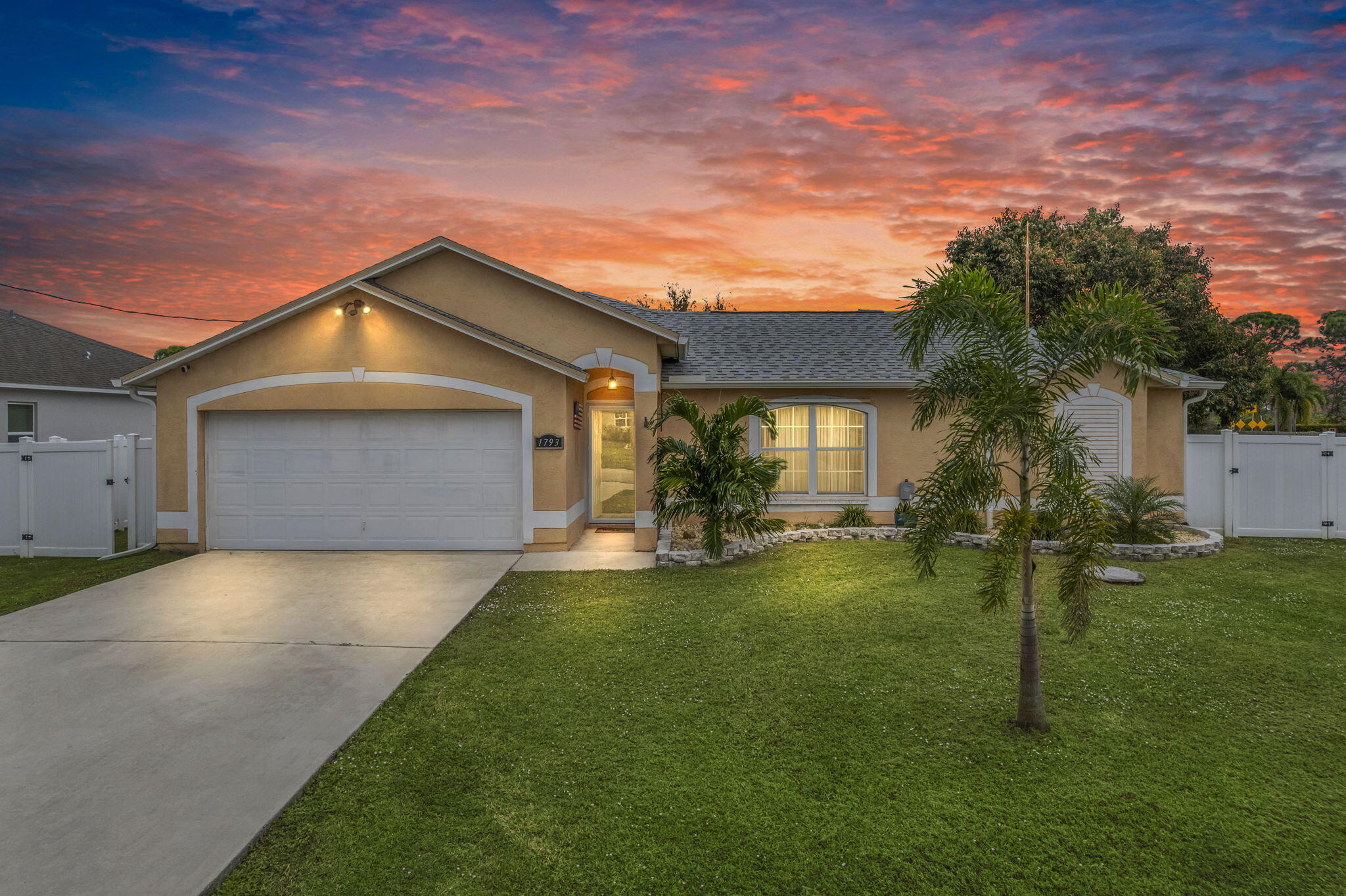 a front view of house with yard and green space