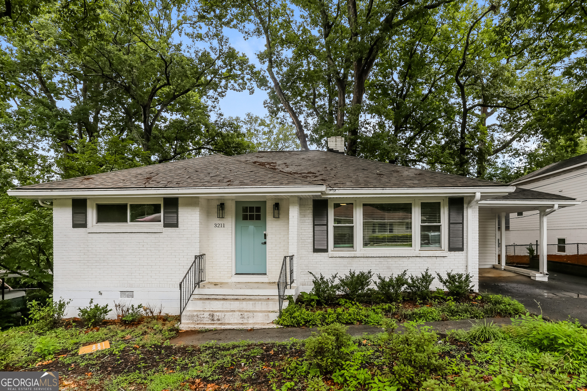 a front view of a house with a garden