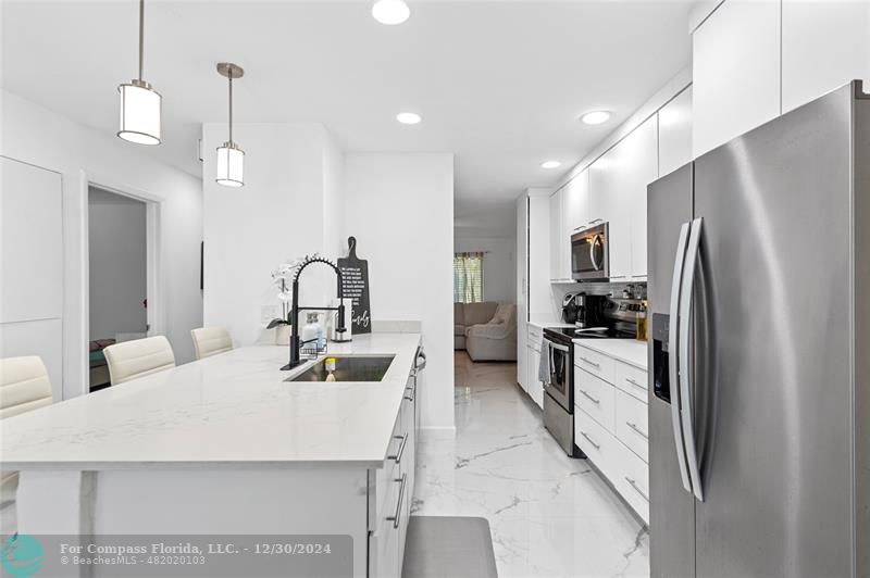 a kitchen with refrigerator a sink and cabinets