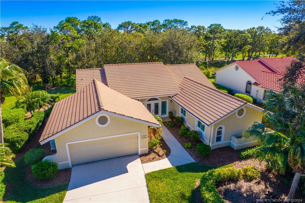 an aerial view of a house with a yard