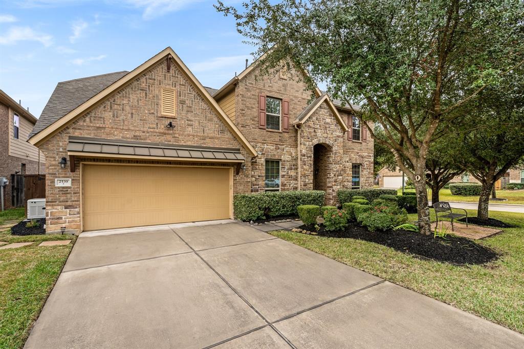 Welcome home to this stunning two-story gem! Boasting a timeless brick and stone façade, this property exudes curb appeal with its meticulously maintained landscaping and mature shade trees. The expansive driveway leads to a two-car garage, offering convenience and practicality. The charming front porch invites you to envision peaceful mornings or cozy evenings surrounded by lush greenery. This home is where elegance meets comfort—perfectly designed for creating cherished memories.