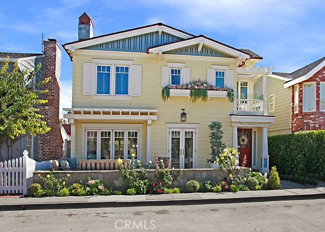 front view of a house with potted plants