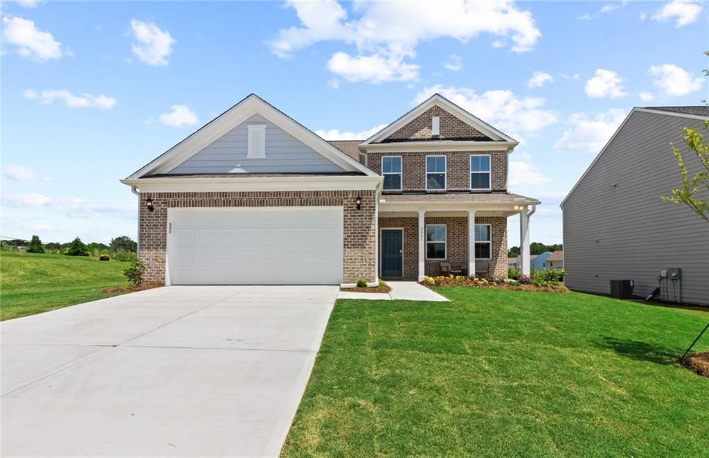 a front view of a house with a yard and garage