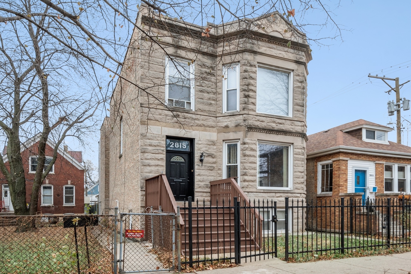 a front view of a house with iron fence