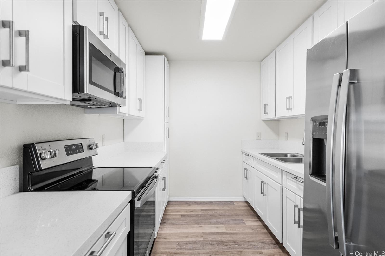 a kitchen with stainless steel appliances sink a microwave and cabinets