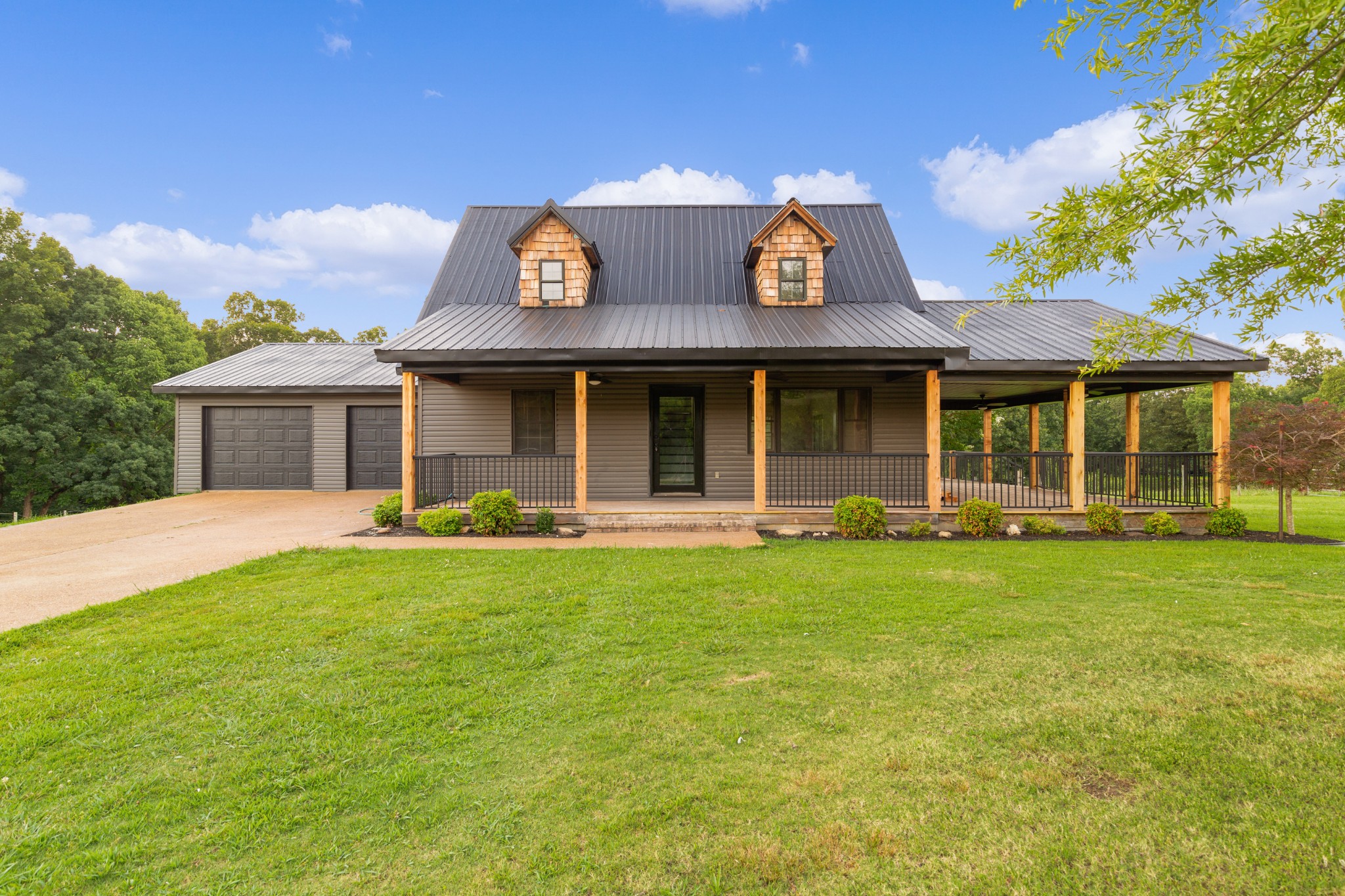 a front view of a house with a garden