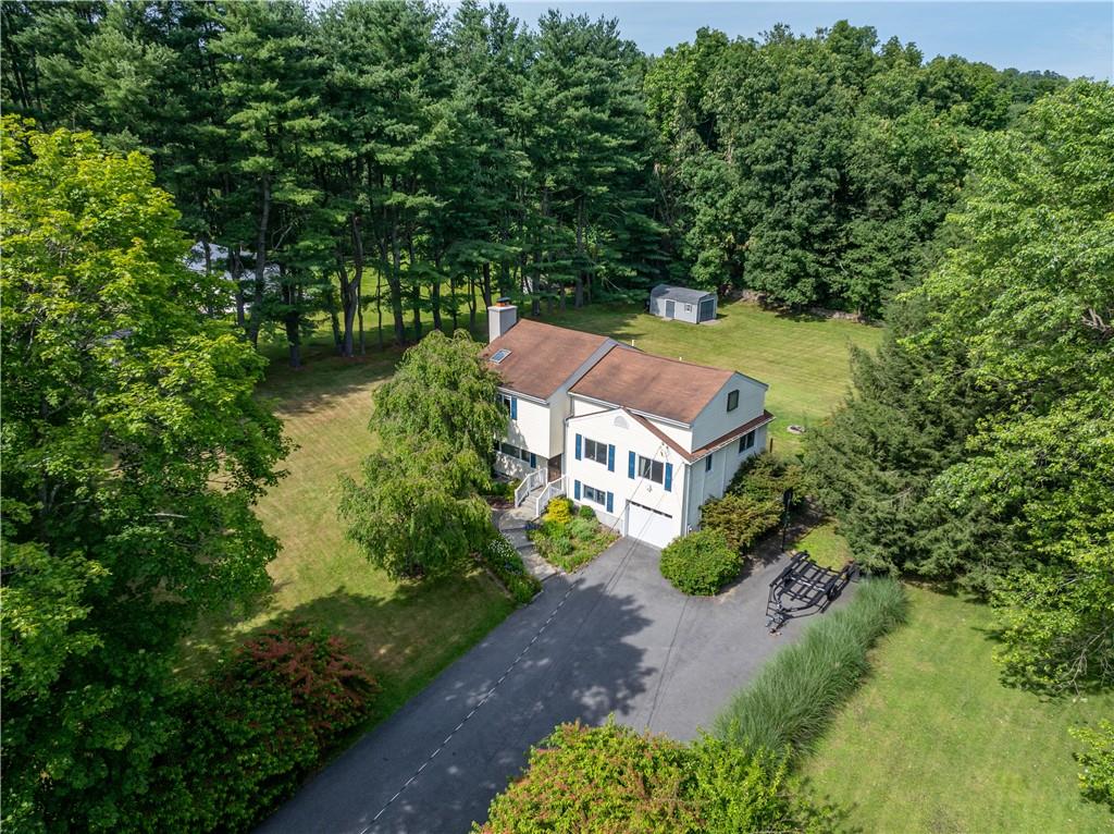 an aerial view of a house with a yard basket ball court and outdoor seating