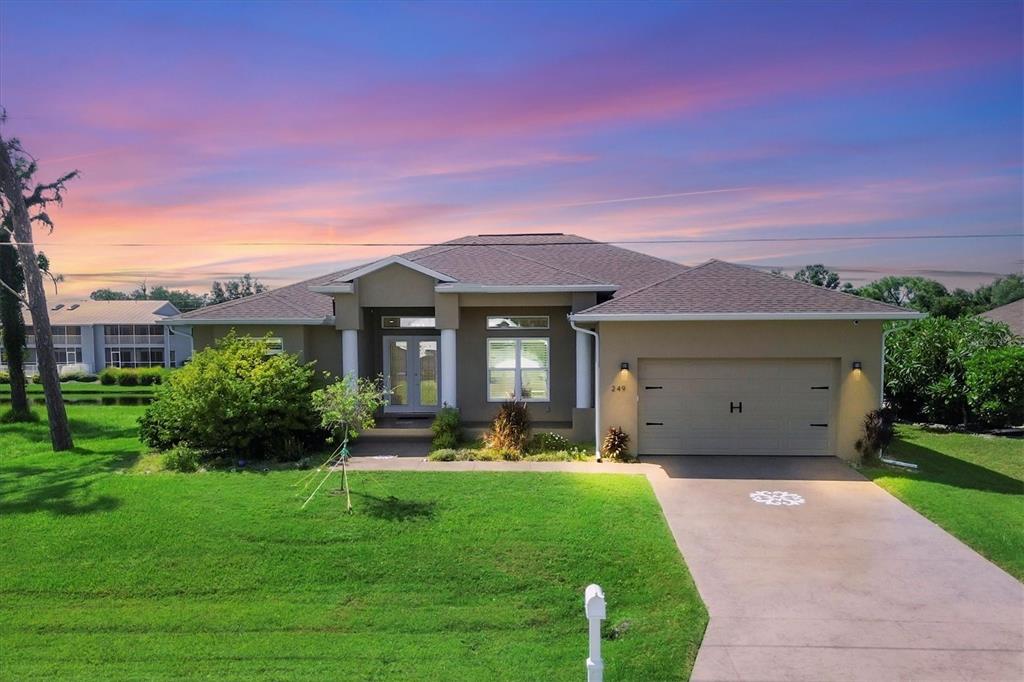 a front view of a house with a yard and a garage