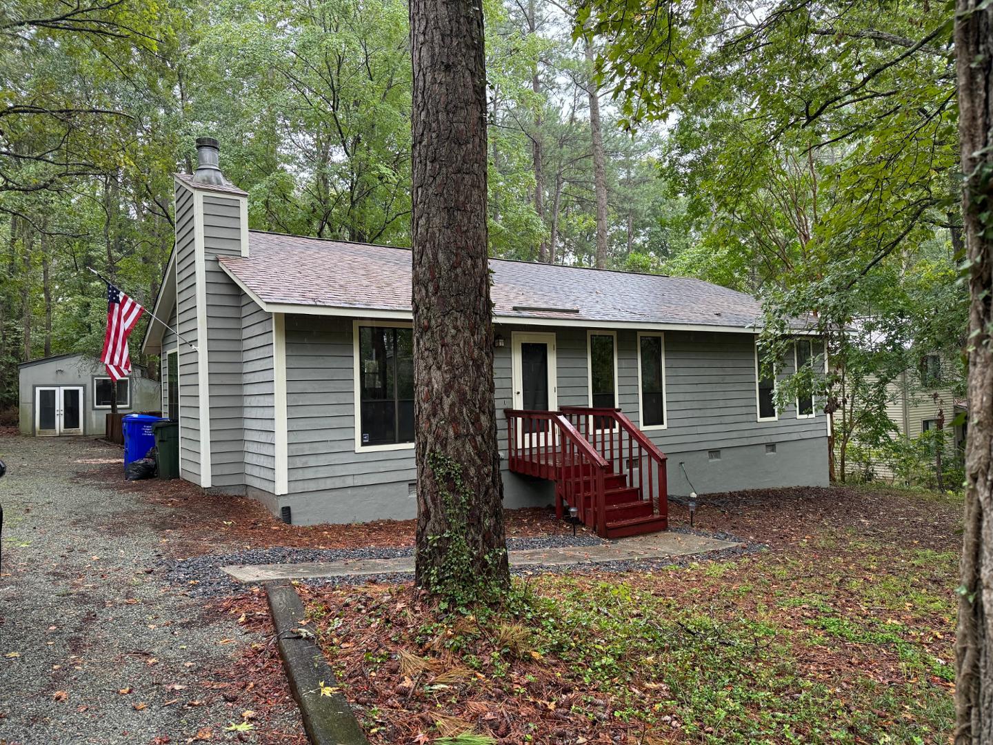 a view of a house with a yard and sitting area