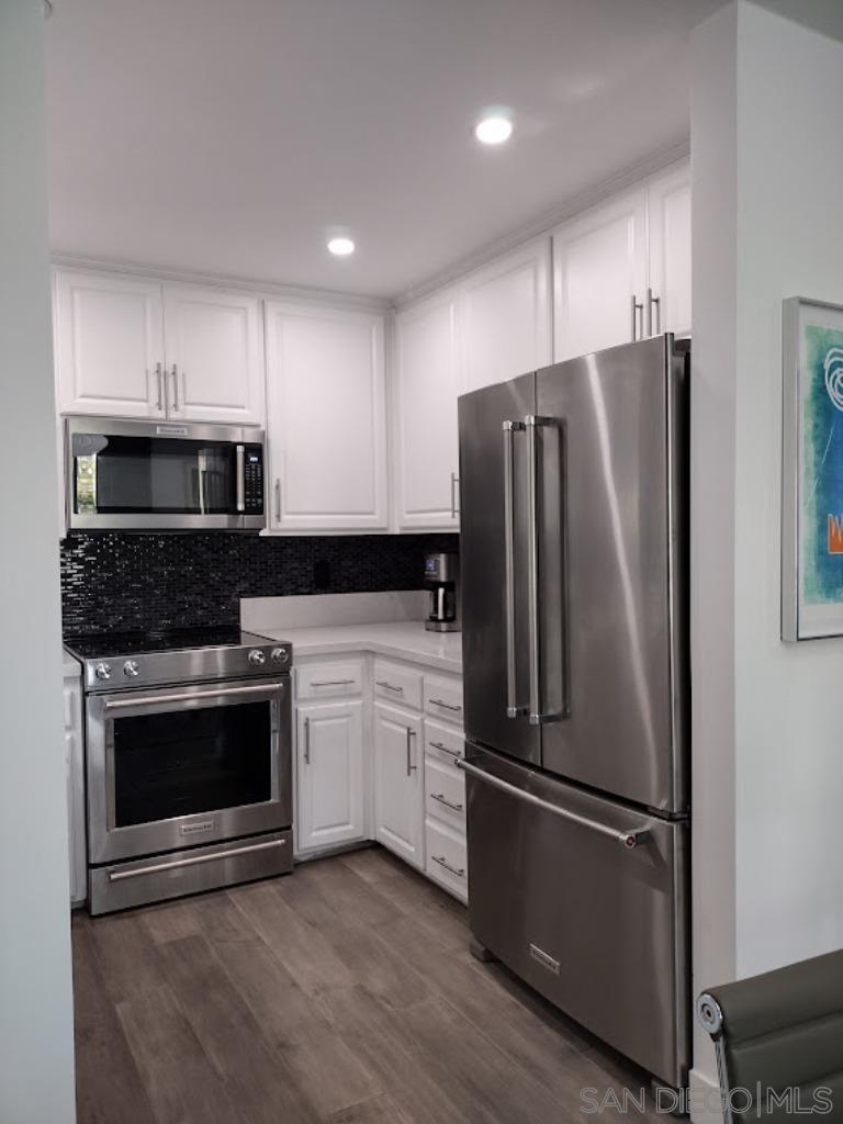 a kitchen with a refrigerator stove and microwave