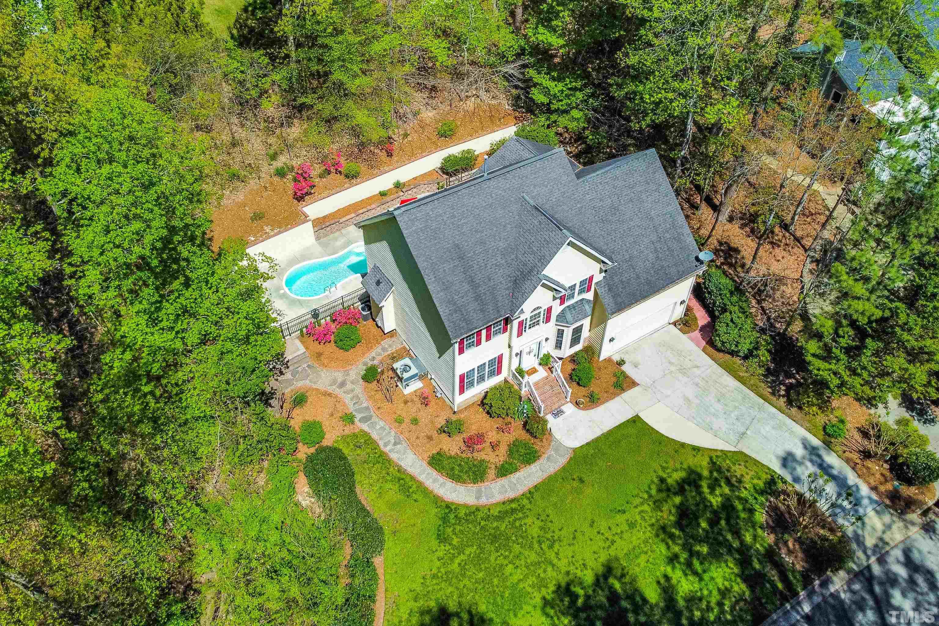 an aerial view of a house with a yard and plants