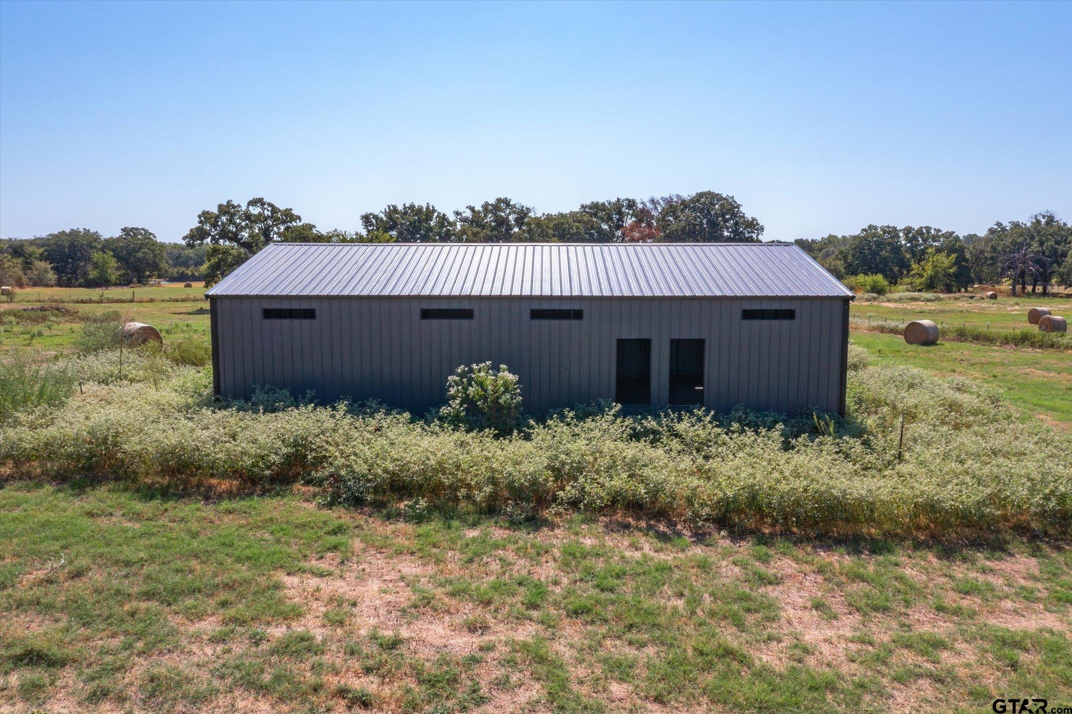 a view of a house with a yard and plants