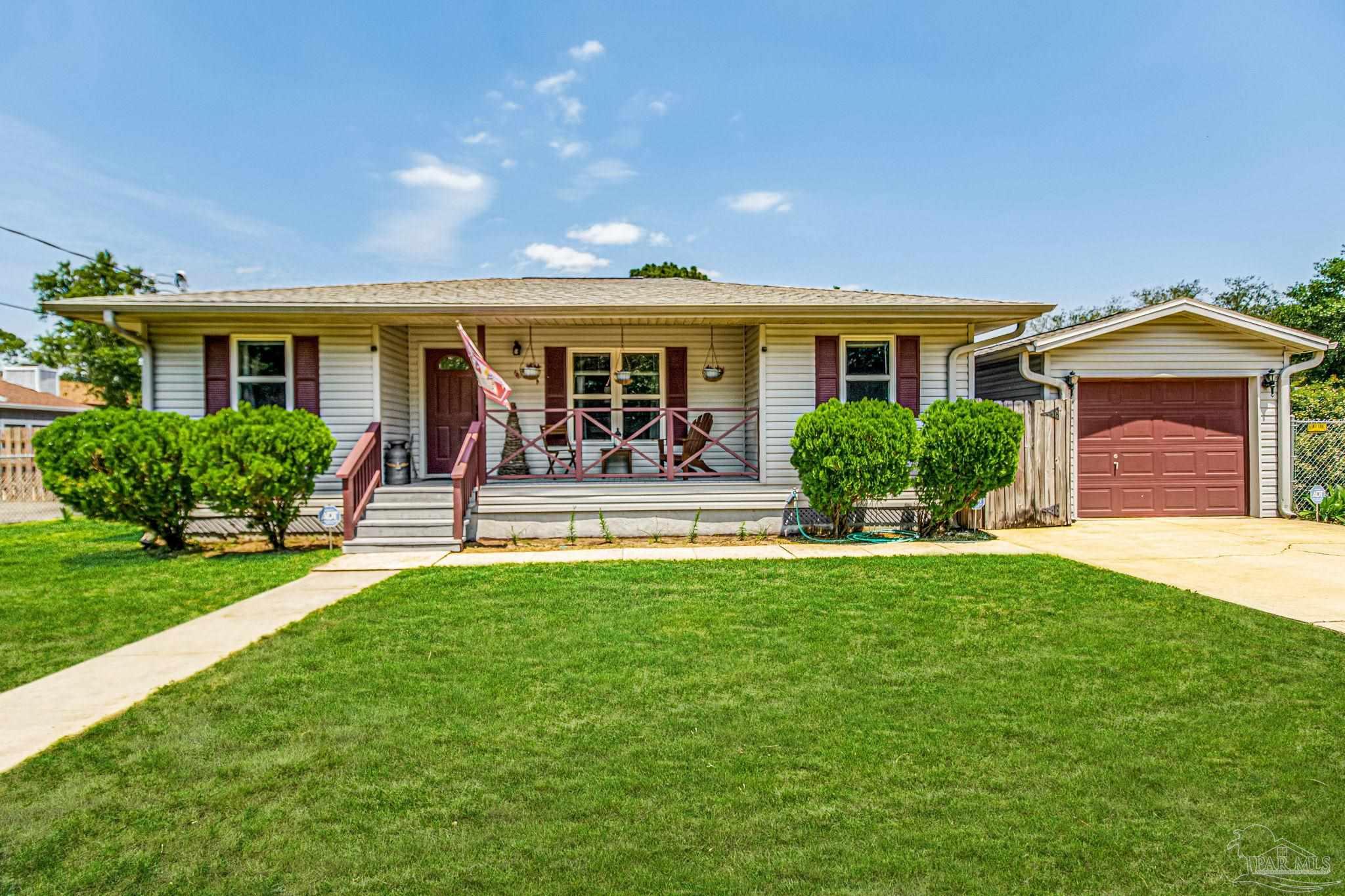 a front view of house with yard and outdoor seating