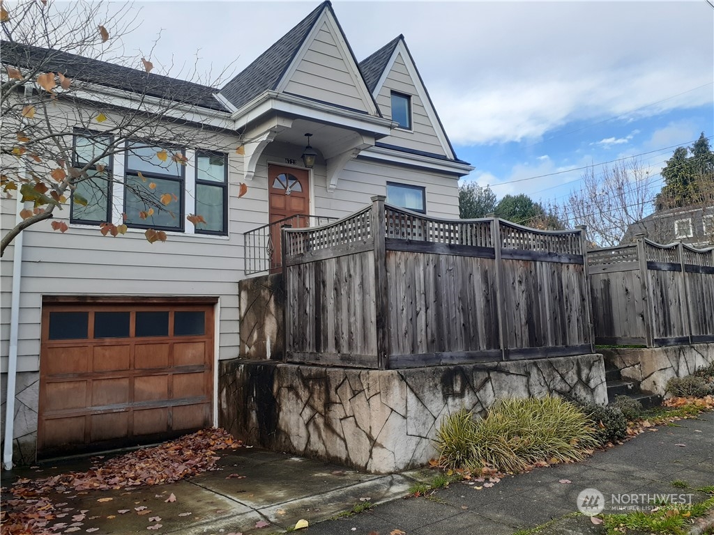 a view of a house with a wooden fence