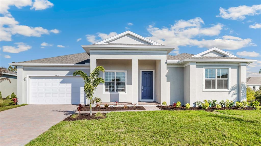 a front view of a house with a yard and garage