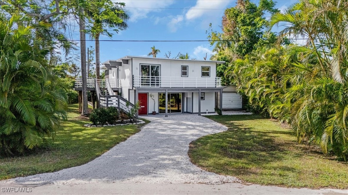 a view of a house with a yard and tree s