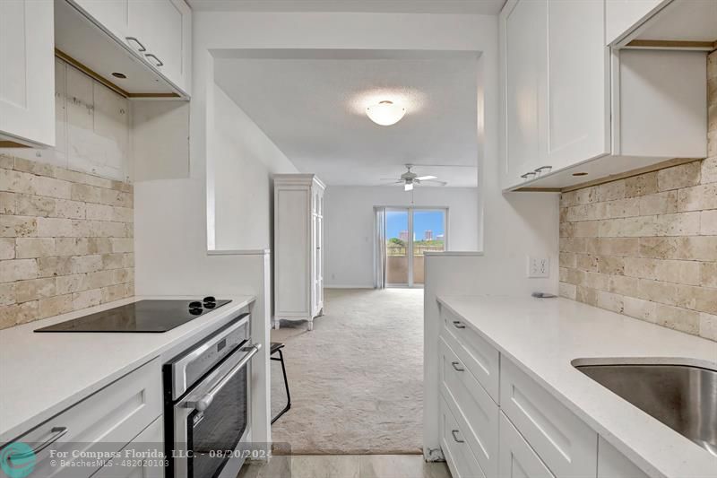 a kitchen with a sink and a refrigerator