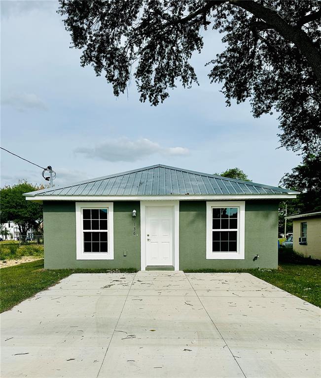 a front view of a house with a garden and garage