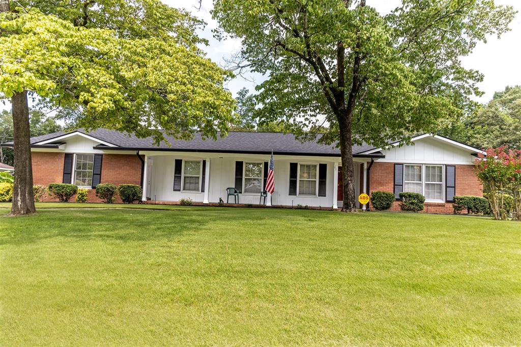 a front view of a house with a garden and porch