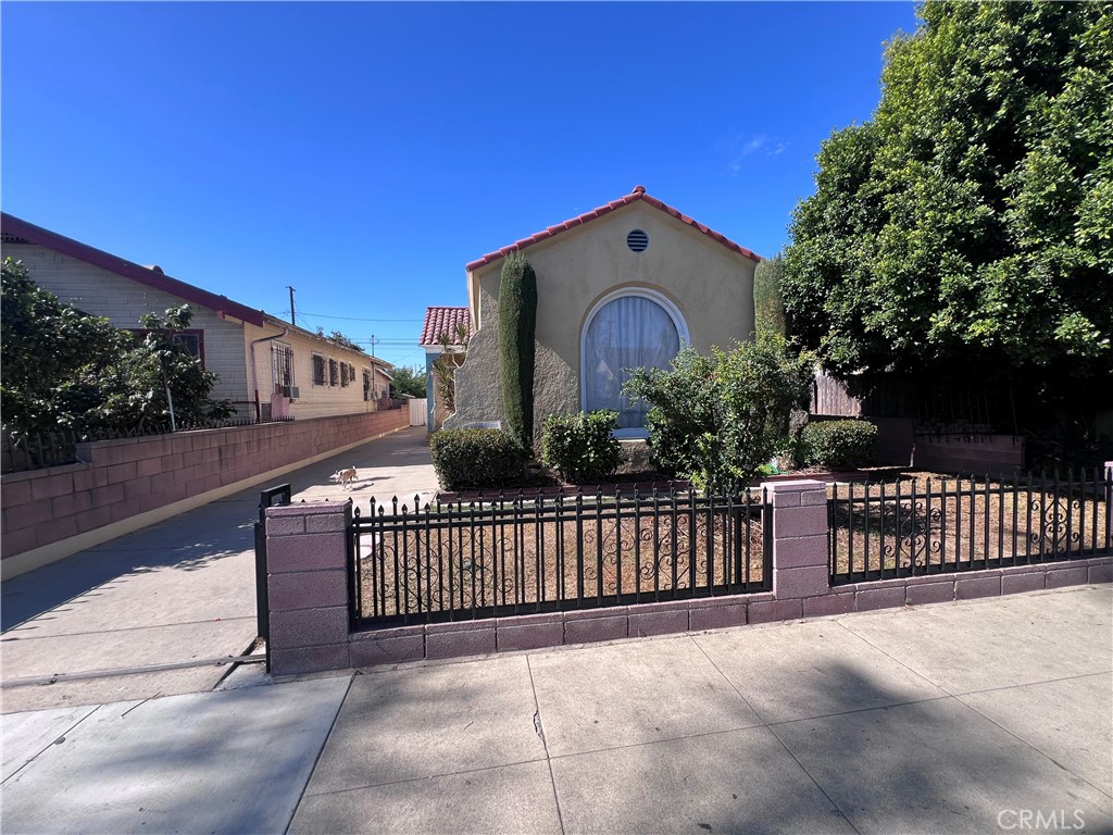 a view of a street with a fence