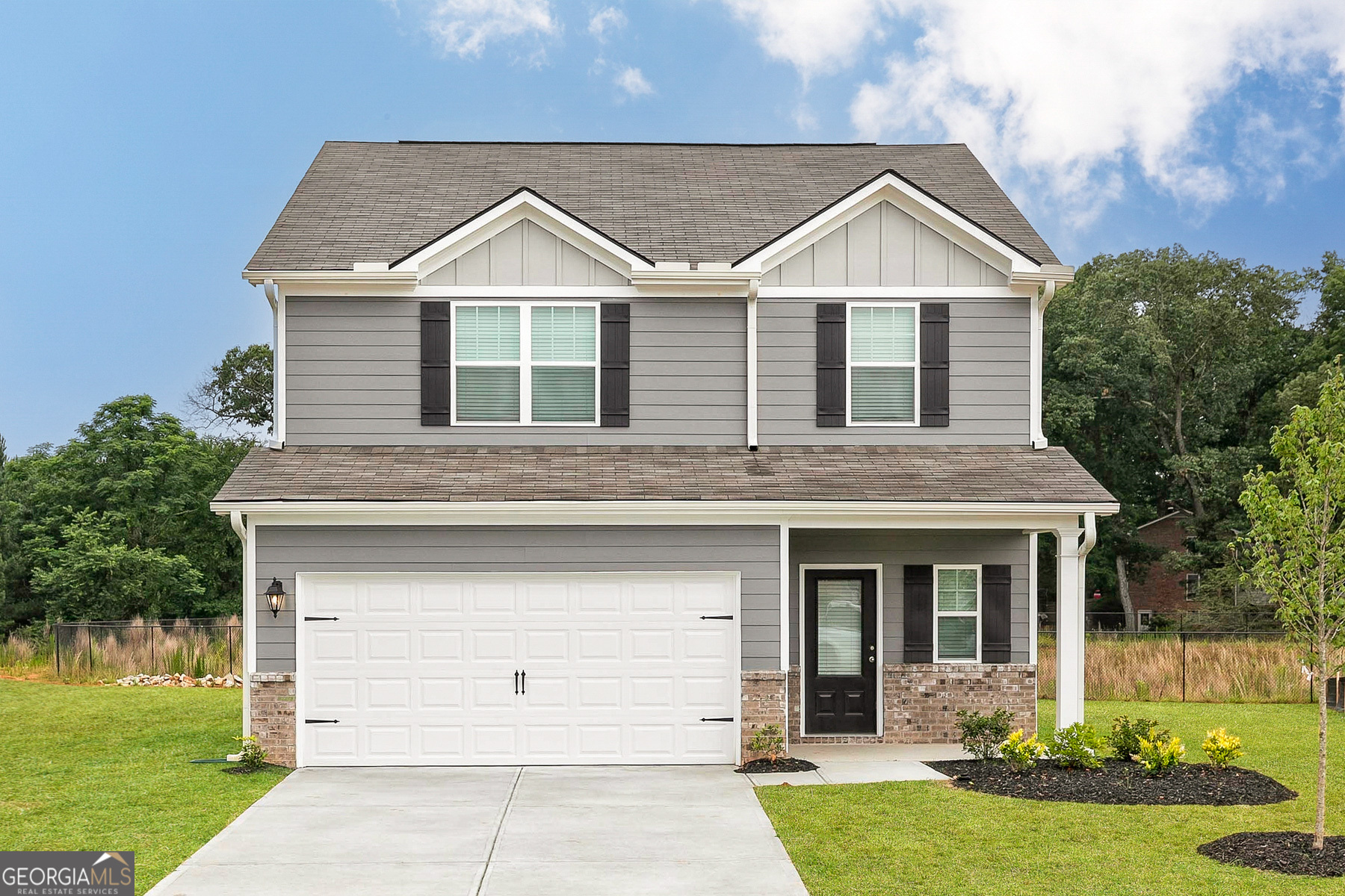 a view of a yard in front view of a house