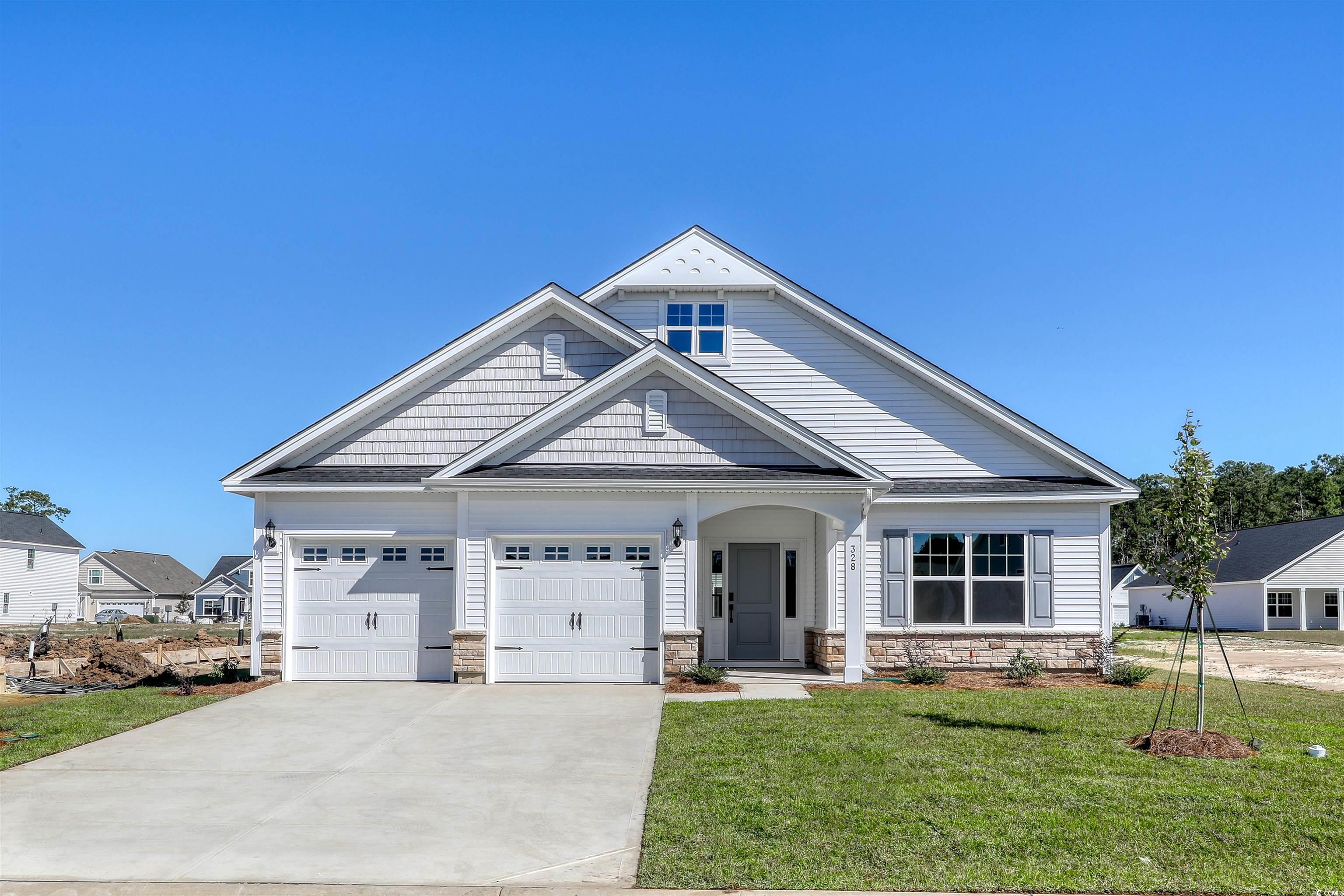 Craftsman-style house with a garage and a front ya