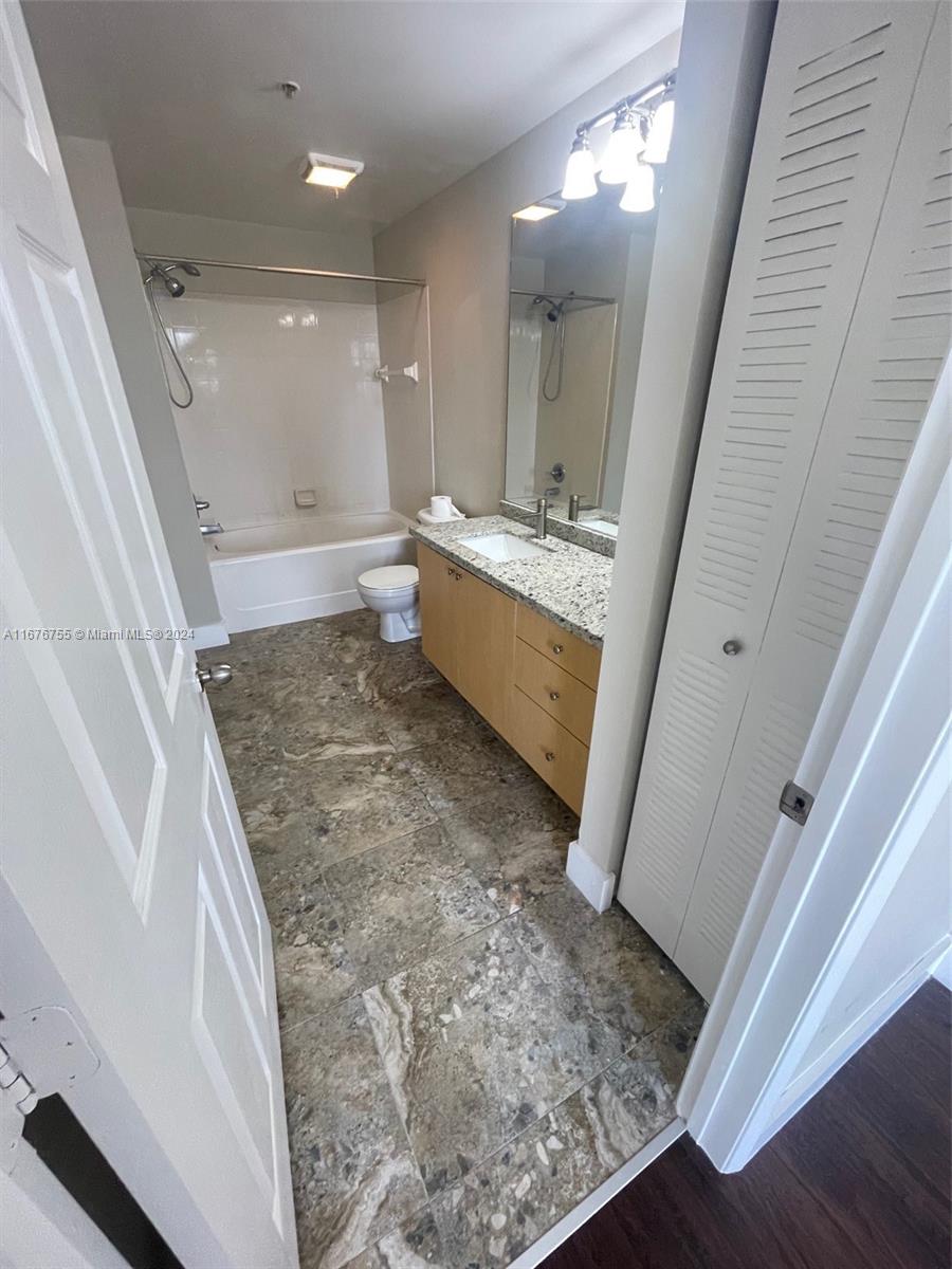 a bathroom with a sink a toilet a mirror and vanity