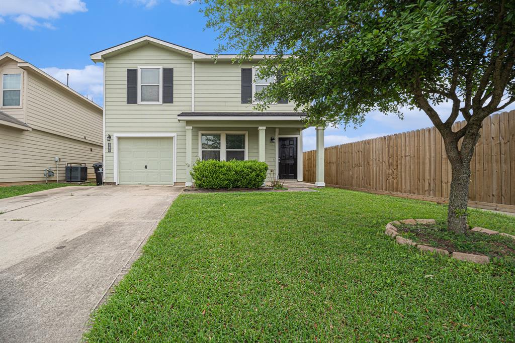 a front view of a house with a garden and yard