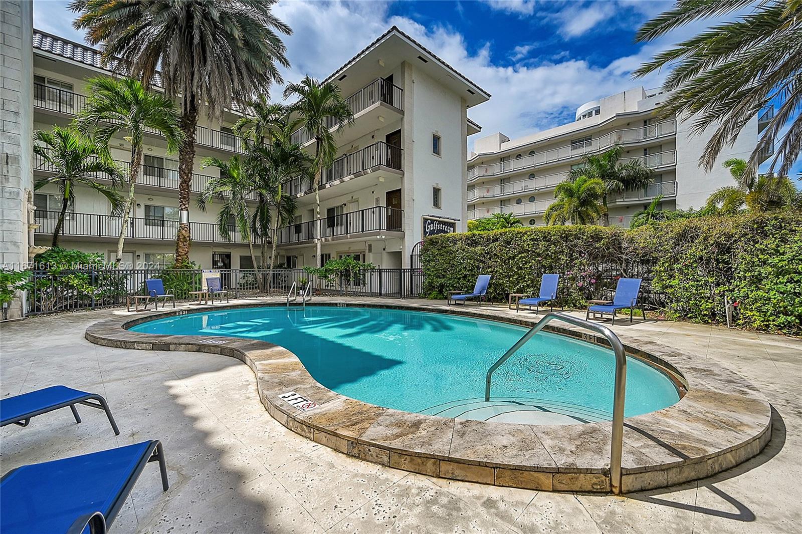 a view of a house with swimming pool and sitting area