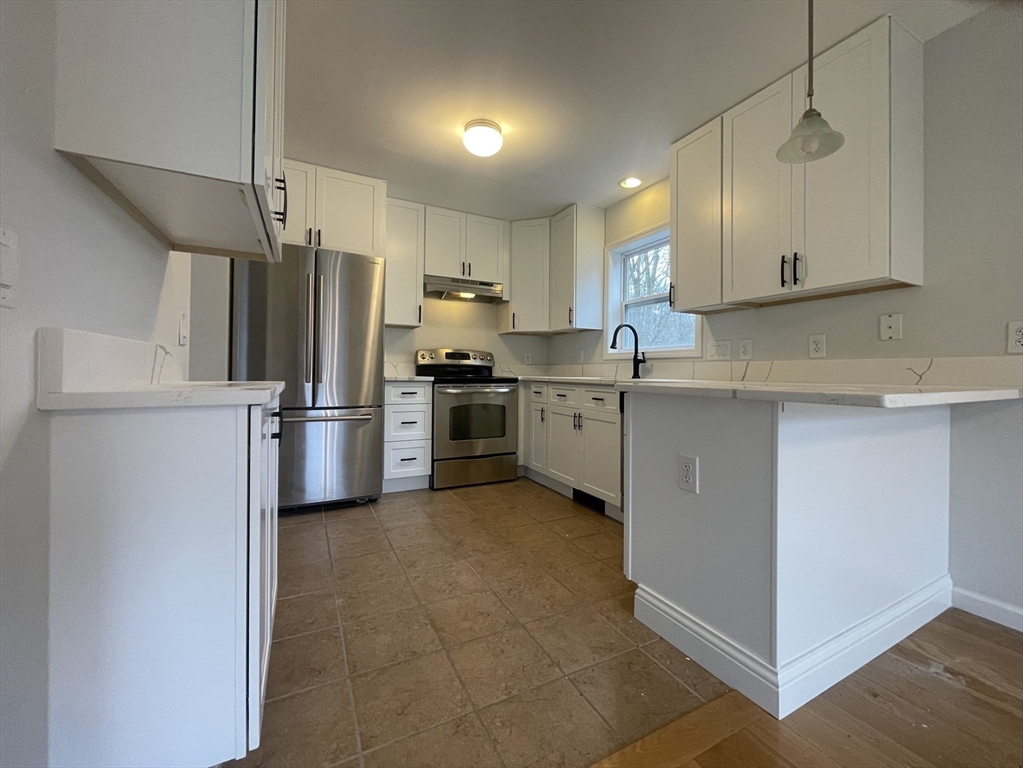 a kitchen with stainless steel appliances granite countertop a refrigerator sink and cabinets