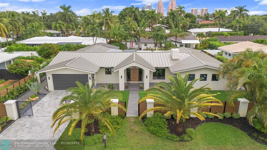 a aerial view of a house next to a yard