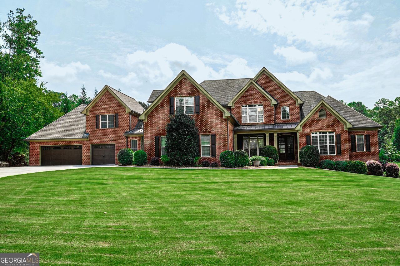 a front view of a house with a yard and garage