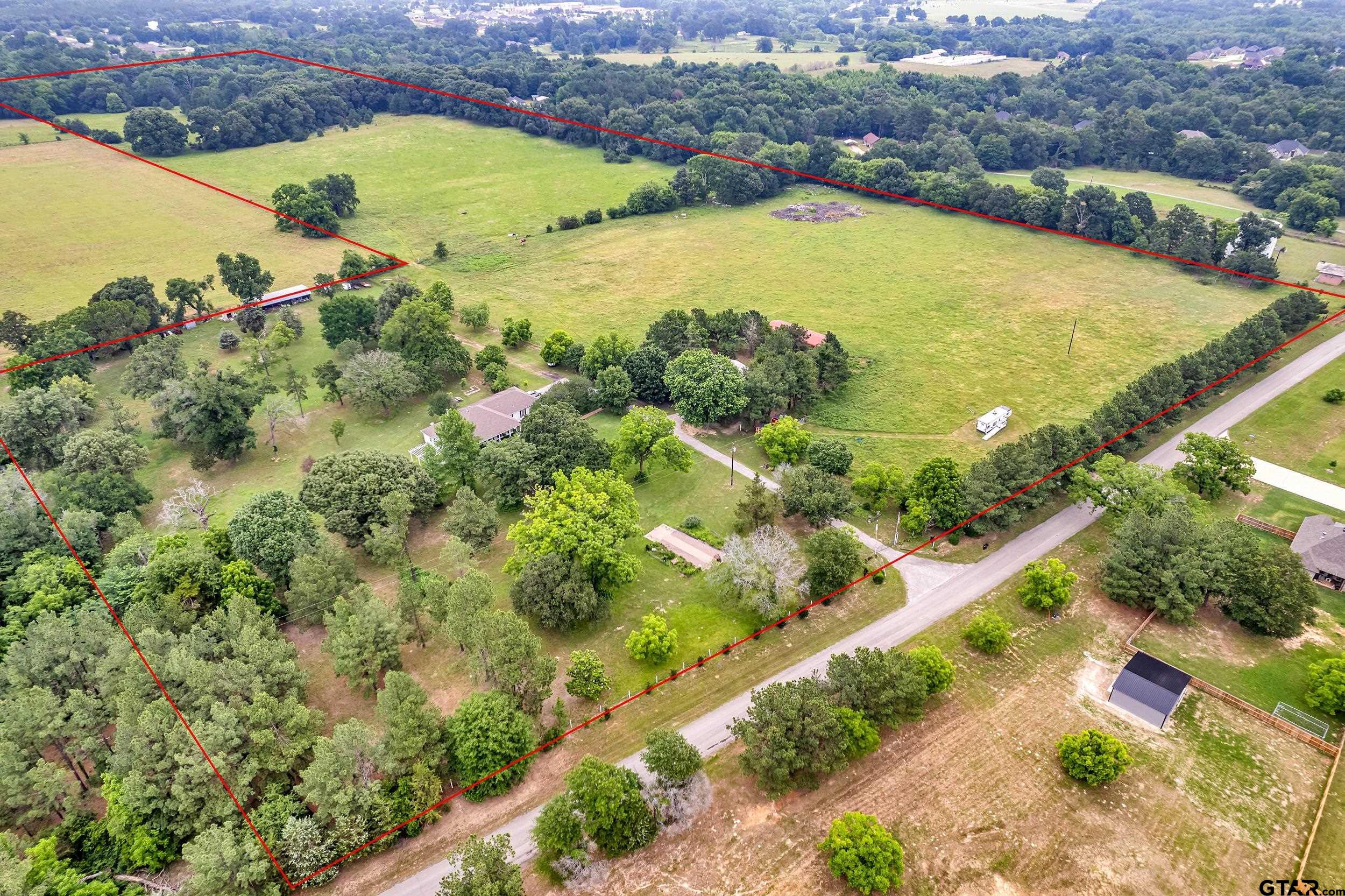 an aerial view of residential houses with outdoor space and river