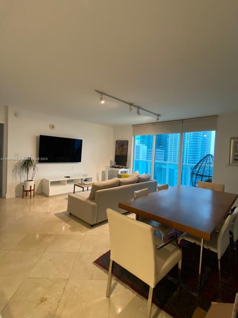 a living room with furniture and flat screen tv