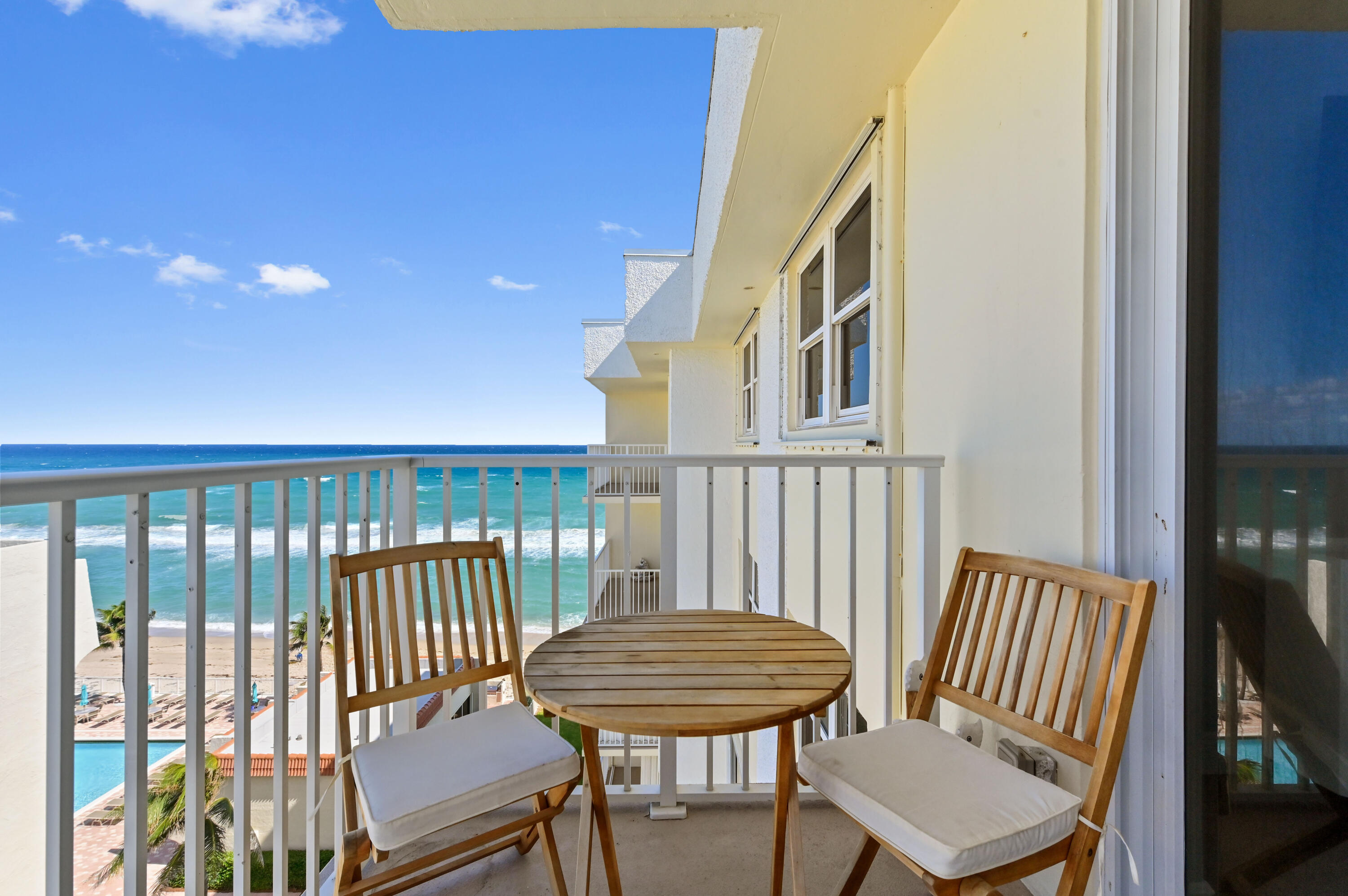 a view of a balcony with furniture