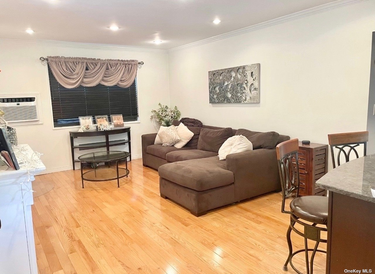 a living room with furniture a rug and a wall painting