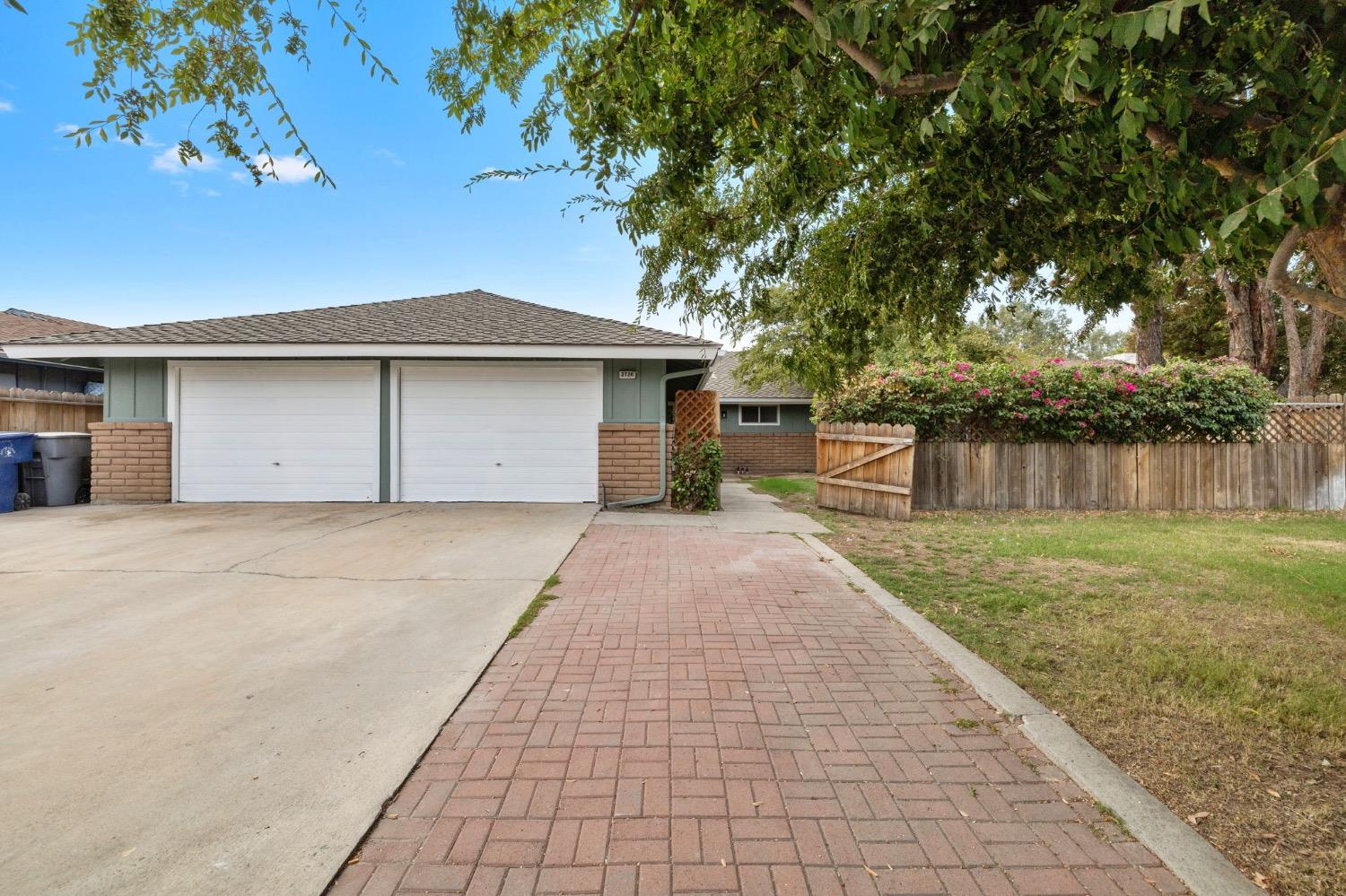 a front view of house with yard and trees