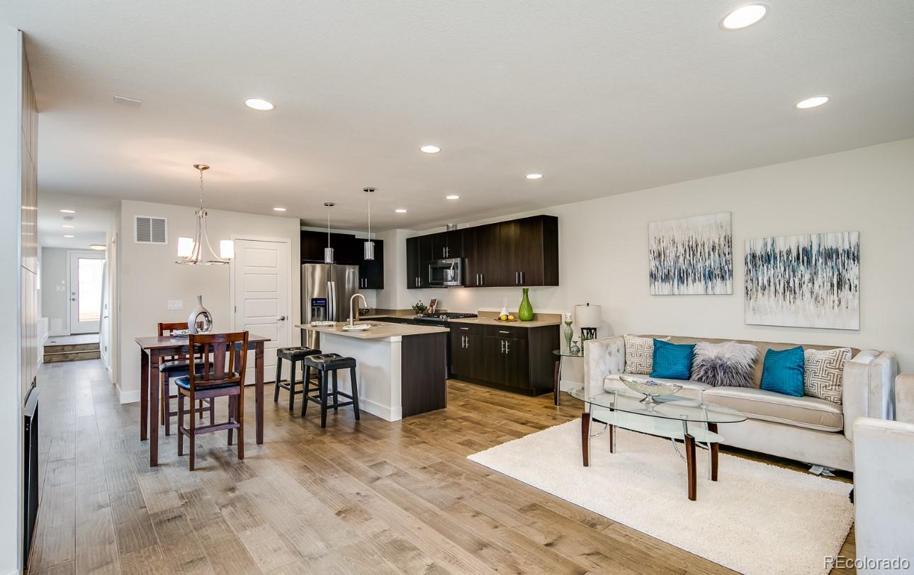 a living room with furniture a kitchen view and a kitchen